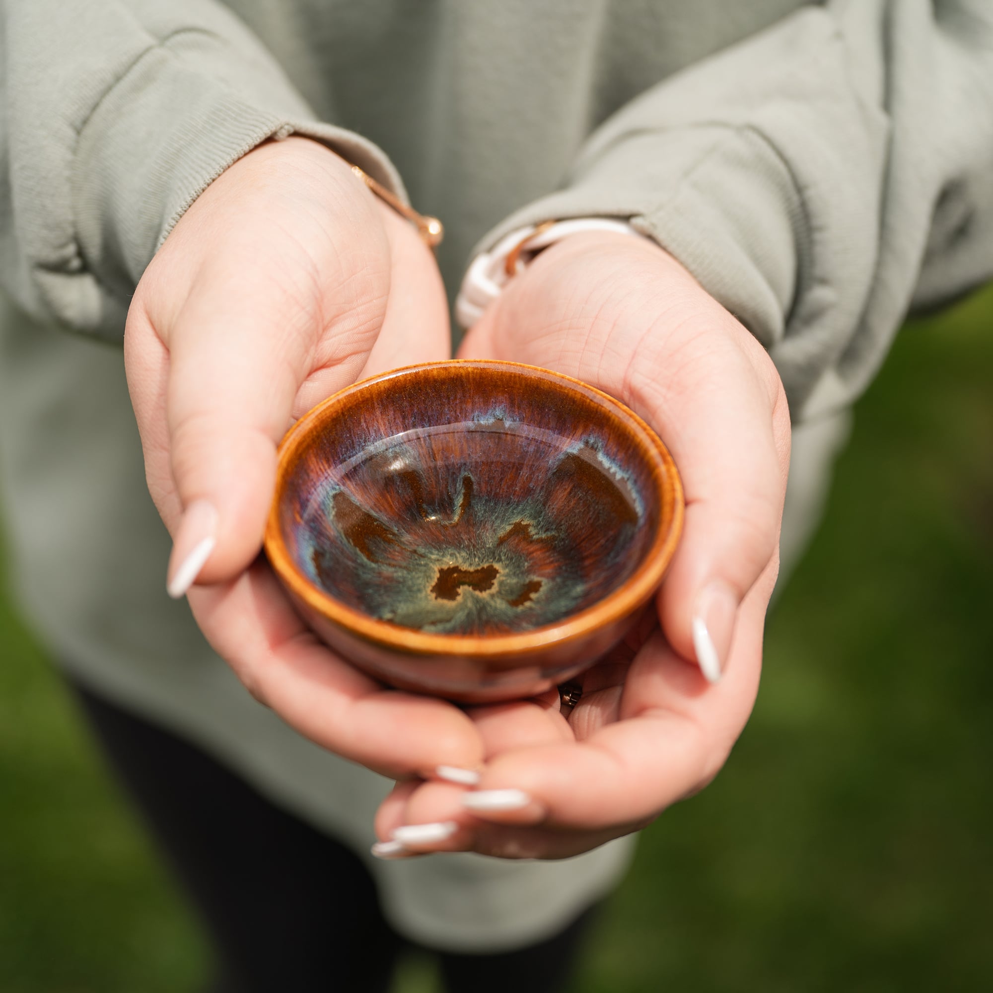 Woman holding pottery bowl symbolizing rest and reset, calm and stillness
