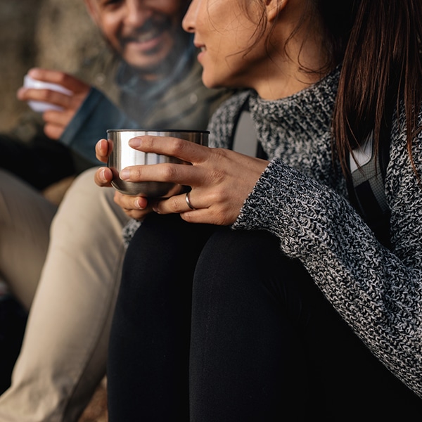 Couple hiking talking rest and drinking coffee in beautiful Whitefish Montana