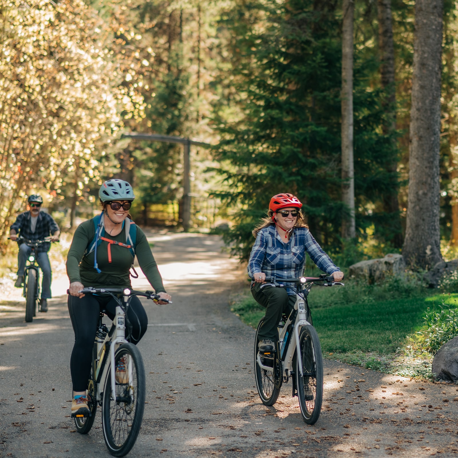 Woman sitting next to a stream on a nature-immersive retreat in Whitefish Montana